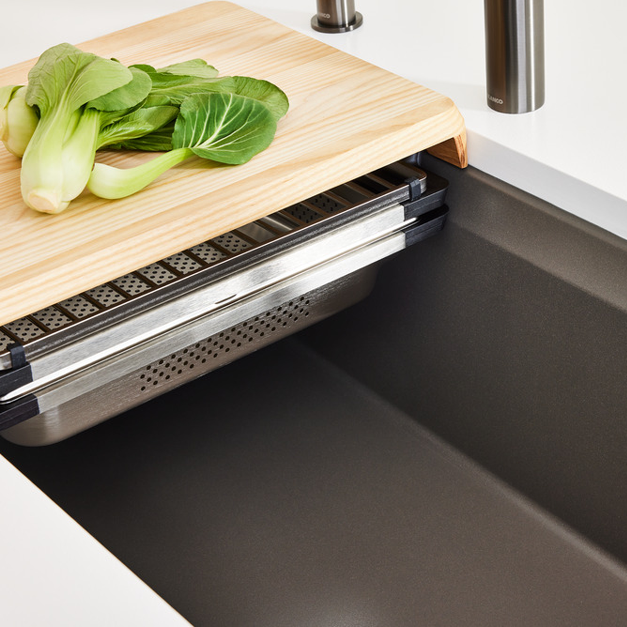 Close up view of Blanco Inteos kitchen workstation sink with wooden chopping board and colander