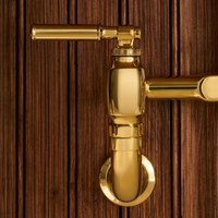 Close-up shot of Brizo Faircroft wall-mount bridge faucet with lever handles in luxe  gold finish