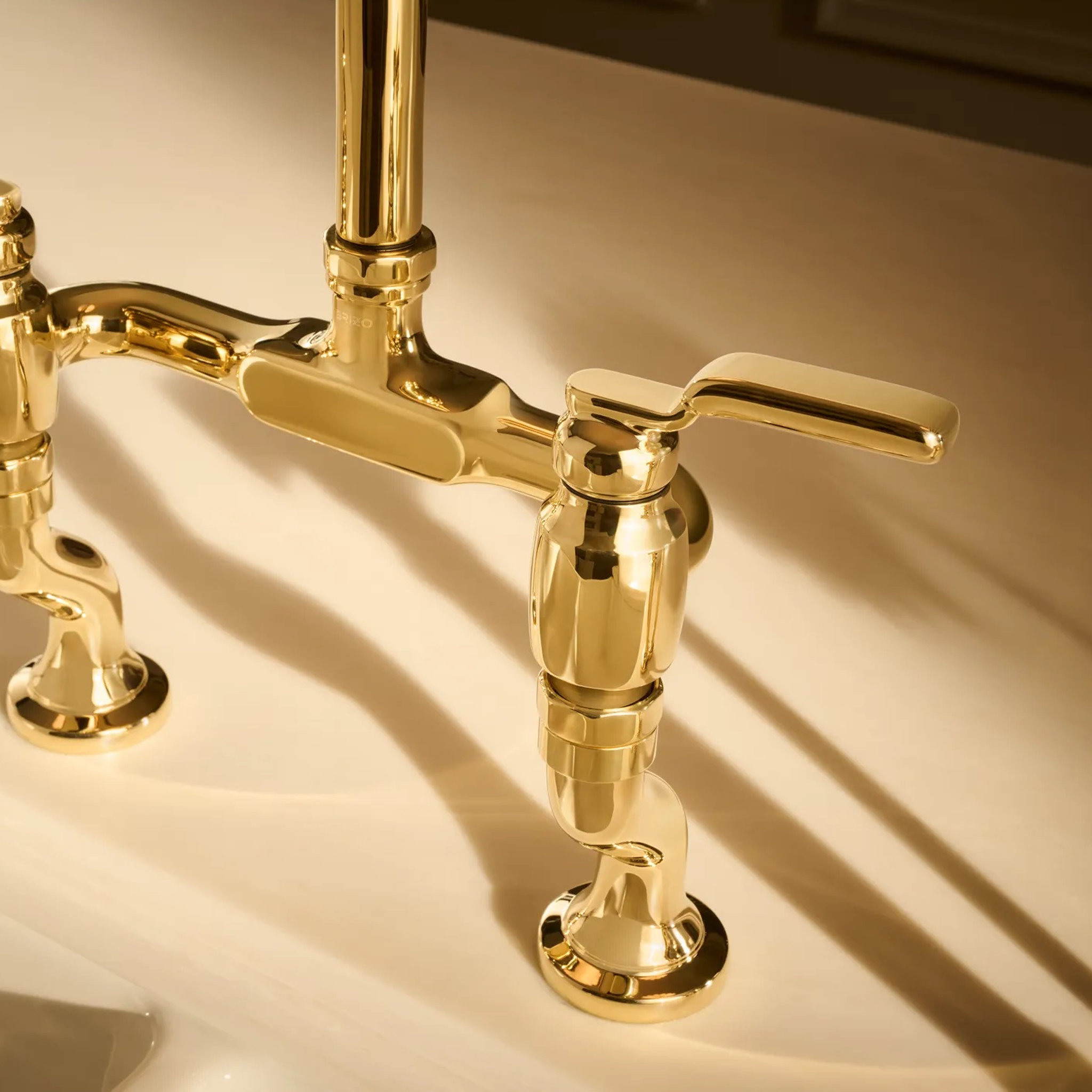 Close up view of Brizo Faircroft bridge faucet industrial lever handle kit in luxe gold
