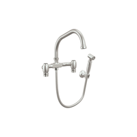 Brizo Faircroft wall-mount bridge faucet with angled spout and side spray in stainless steel