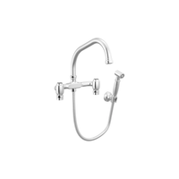 Brizo Faircroft wall-mount bridge faucet with angled spout and side spray in polished chrome