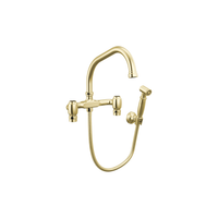 Brizo Faircroft wall-mount bridge faucet with angled spout and side spray in unlacquered brass