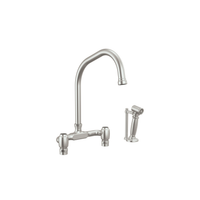 Brizo Faircroft deck-mount bridge faucet with angled spout and side spray in stainless steel
