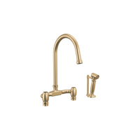 Brizo Faircroft deck-mount bridge faucet with arc spout and side spray in luxe gold