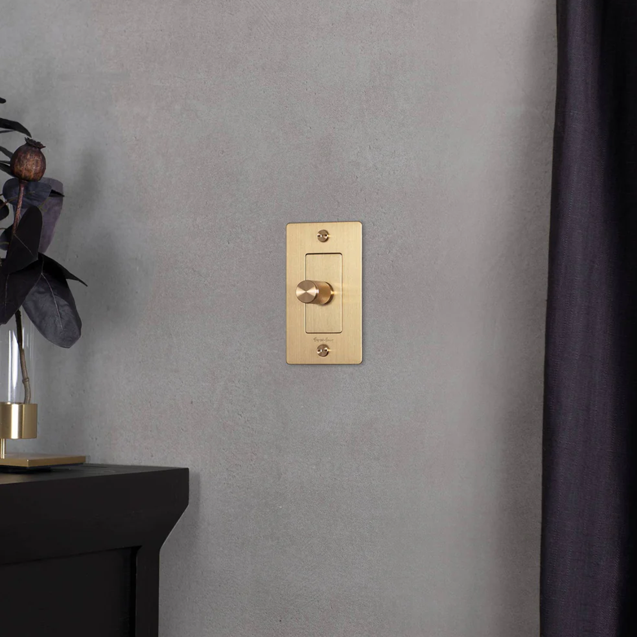 Buster and Punch 1 Gang Cross Dimmer Switch in in Brass on wall