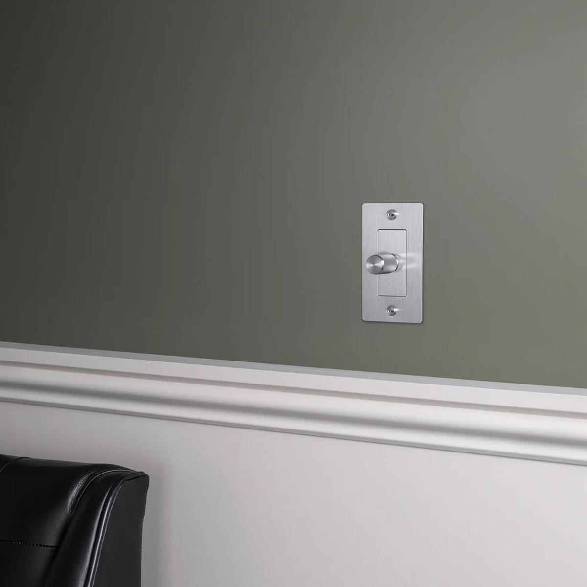 Buster and Punch 1 Gang Dimmer Switch in Steel shown on wall.