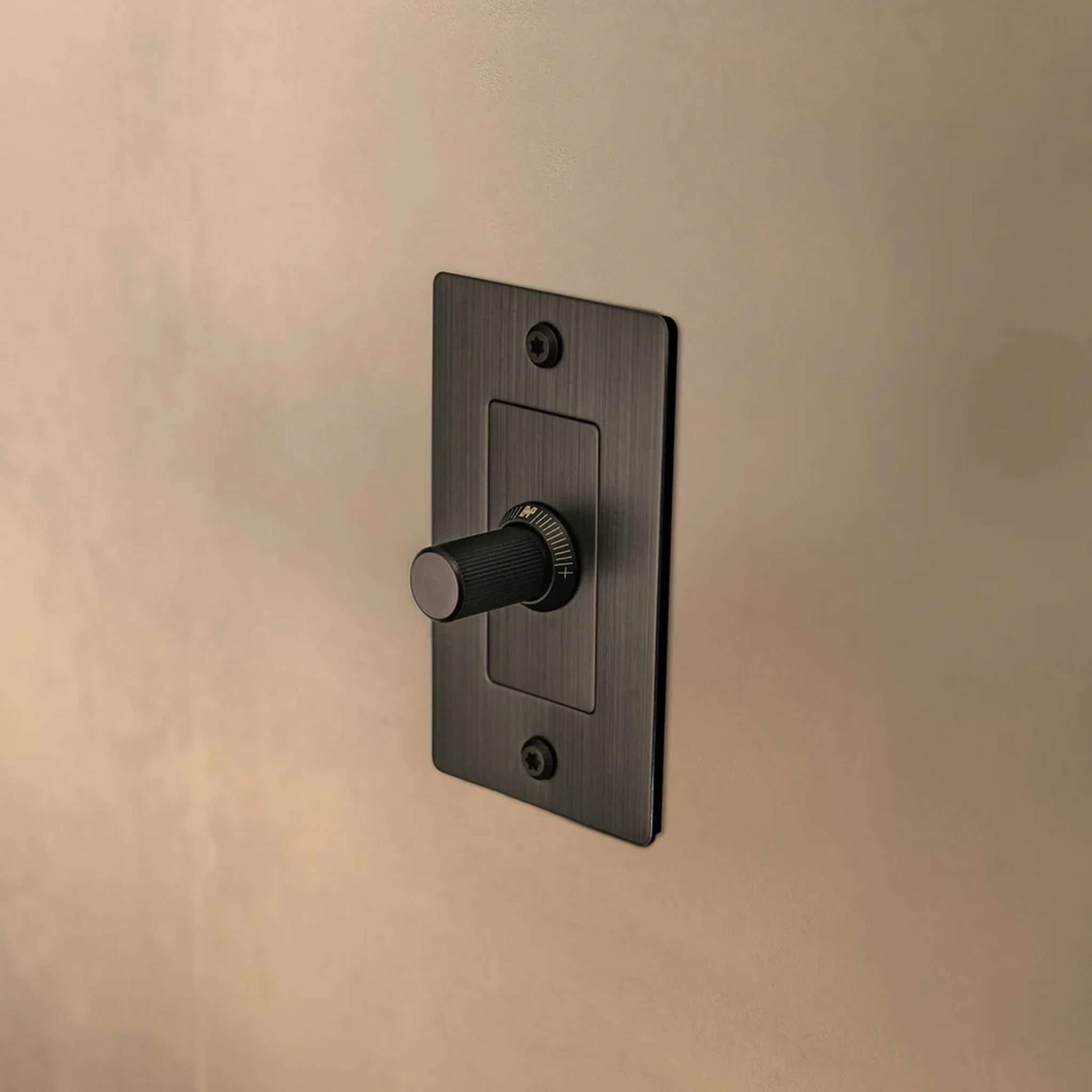 Side view of Buster and Punch 1 Gang LED Linear Dimmer Switch in Black on wall.