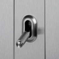Close up view of Buster & Punch Silver Light Switch Toggle with Cross detail