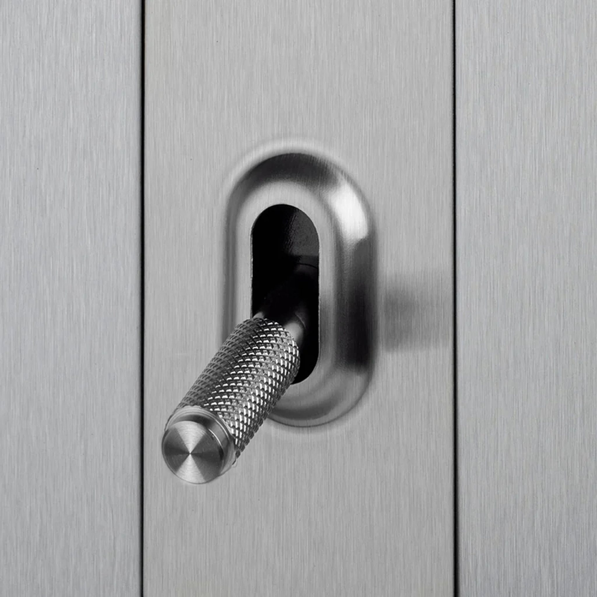 Close up view of Buster & Punch Silver Light Switch Toggle with Cross detail