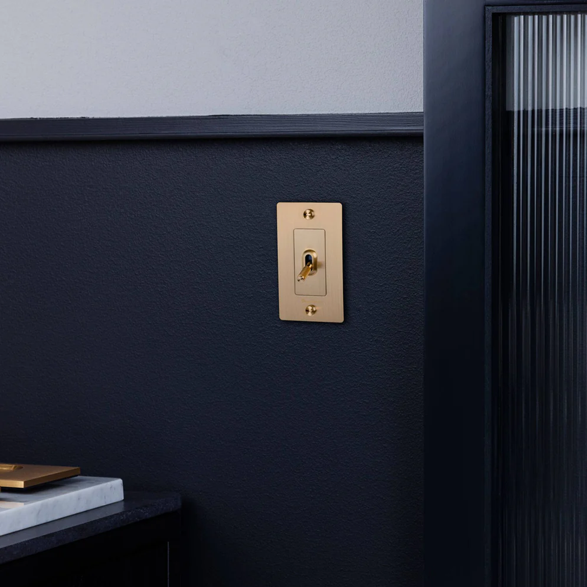 Buster & Punch Brass Light Switch 1 Gang Toggle with Cross design in bathroom