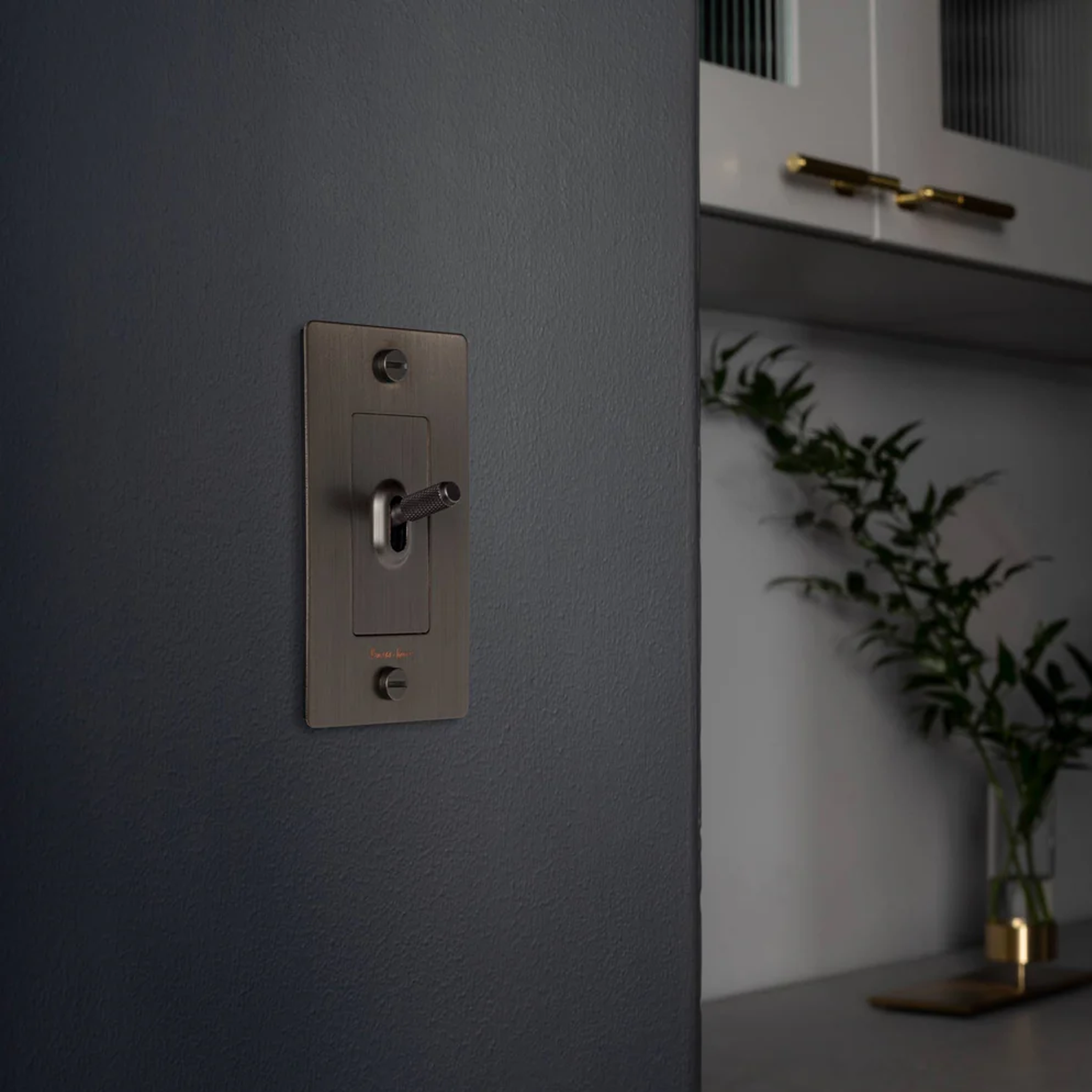 Buster & Punch Steel Light Switch 1 Gang Toggle with Cross design on Wall