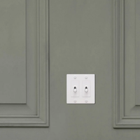Buster & Punch White Light Switch 2 Gang Toggle with Cross design on Wall