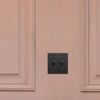 Buster & Punch Black Light Switch 2 Gang Toggle with Cross design on Wall