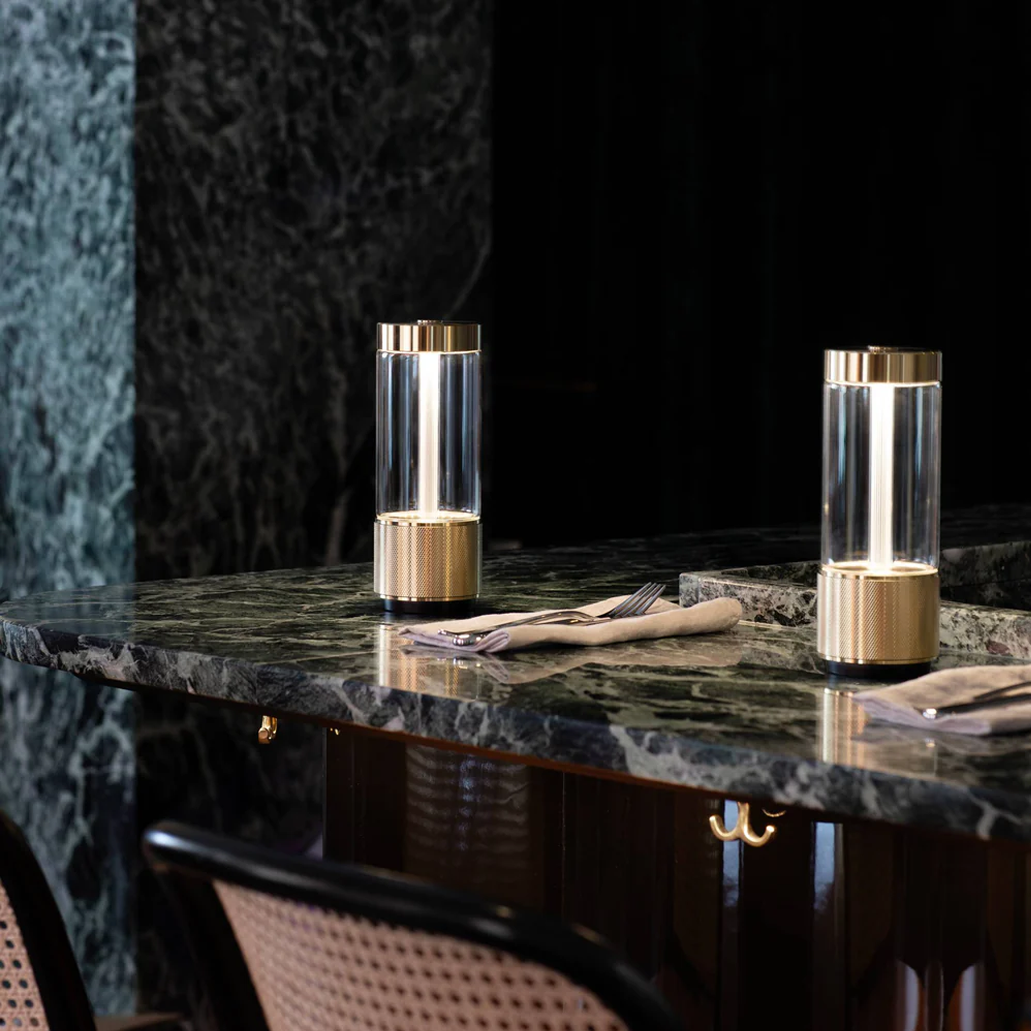 Buster and Punch Takeout Portable Table Light in Brass finish in dining setting