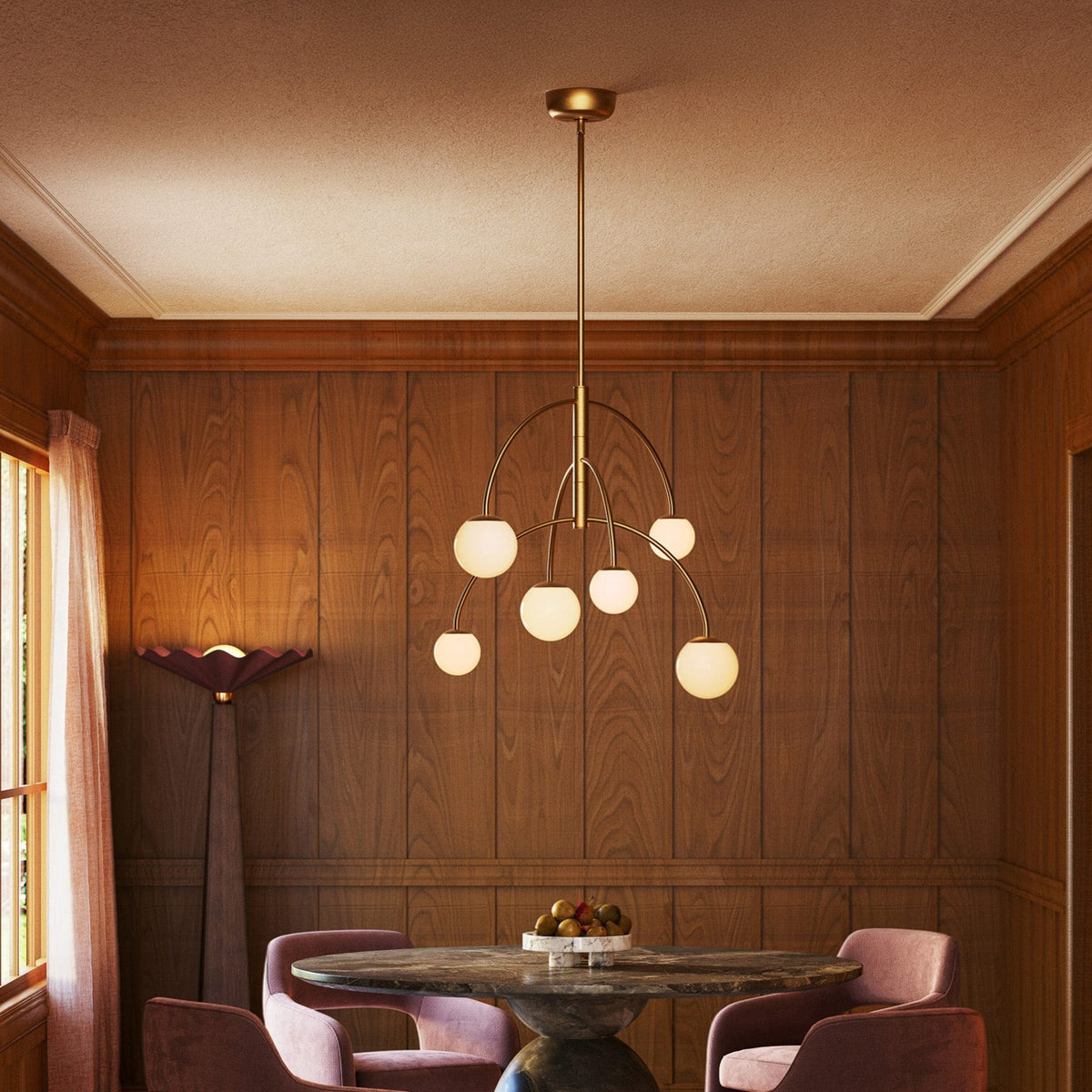 Alora Fiona Chandelier in brushed gold with matte opal glass hanging over dining table