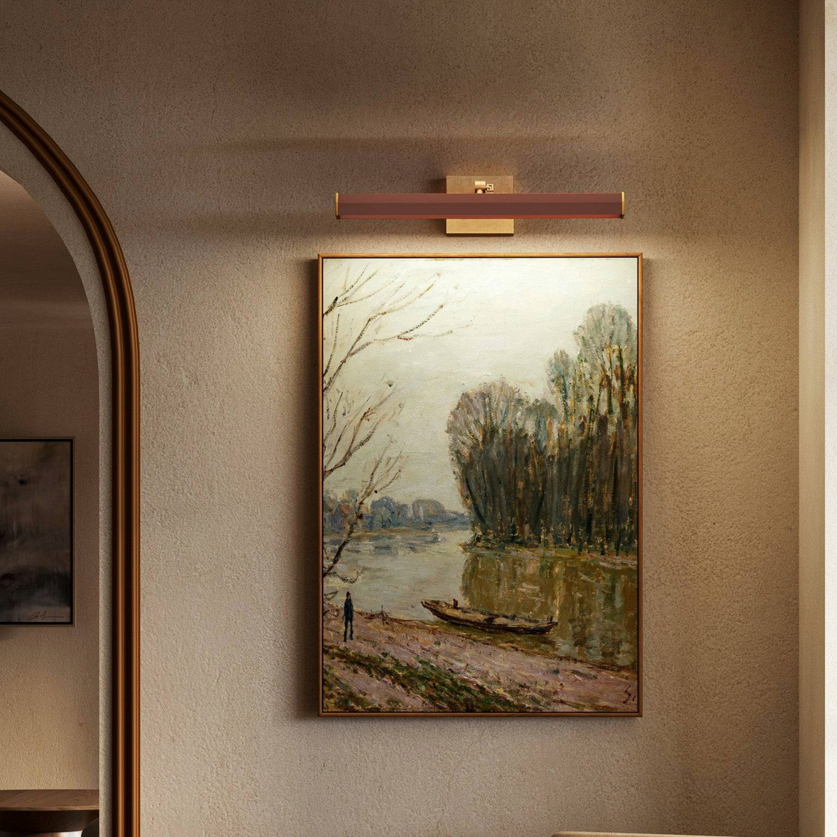 Framed landscape painting illuminated by a modern Alora Gemma Wall/ Picture Light 