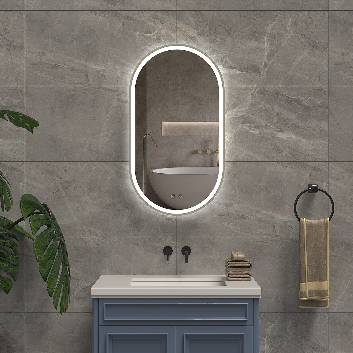 Bathroom with a vanity, illuminated mirror, and towels on a gray tiled wall.