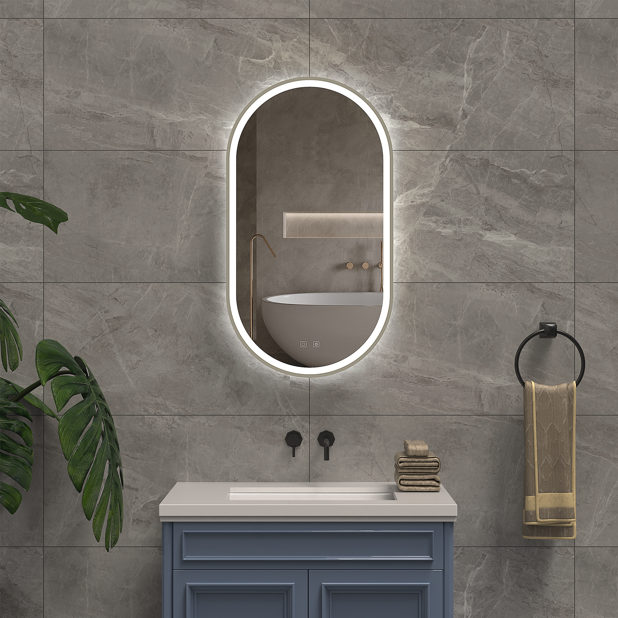 Bathroom with a vanity, illuminated mirror, and towels on a gray tiled wall.