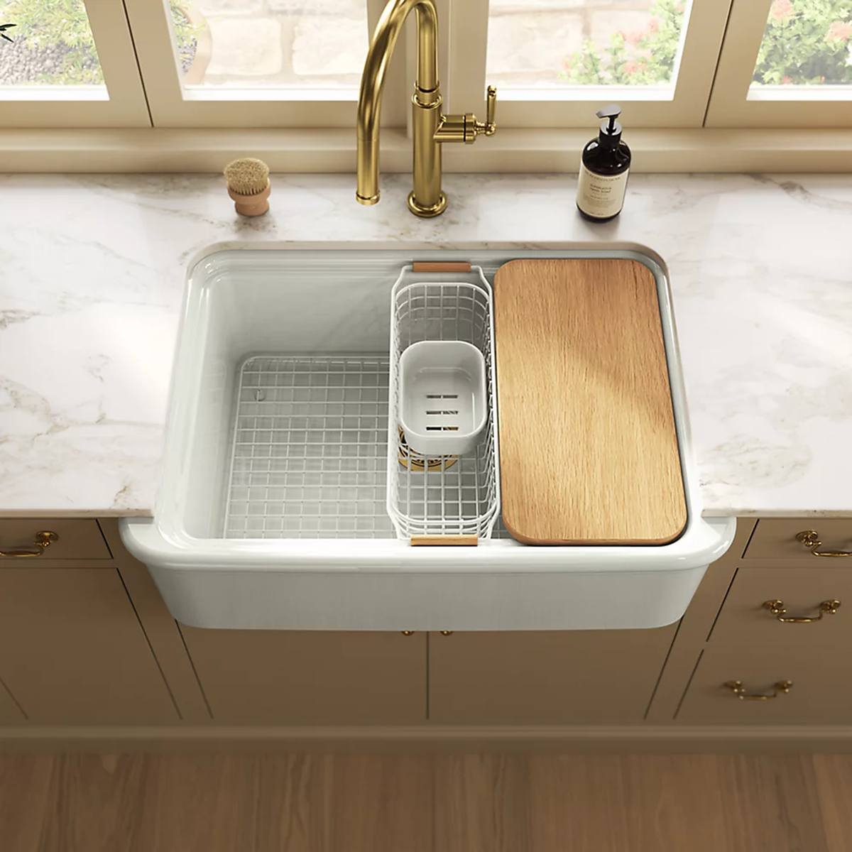 Audrine undermount single-bowl farmhouse kitchen sink by Kohler with wooden cutting board