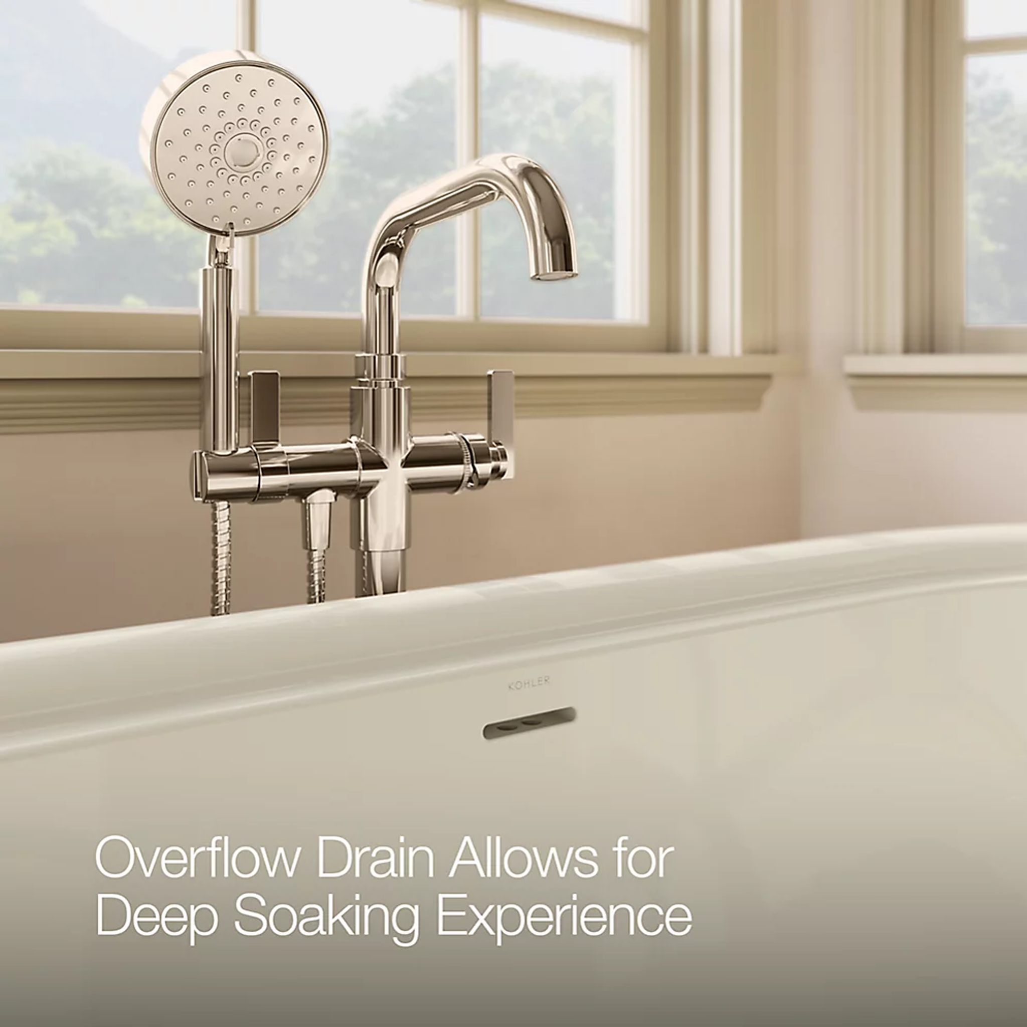Close-up of Kohler CLAUDE™ freestanding bathtub faucet and overflow drain.