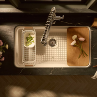 AUDRINE™ undermount single-bowl kitchen sink by Kohler with wooden cutting board