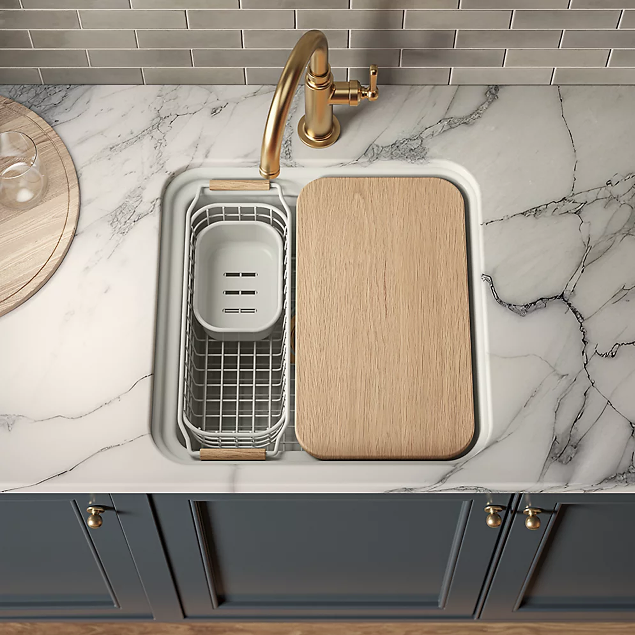 AUDRINE™ undermount bar sink by Kohler with wooden cutting board and gold faucet