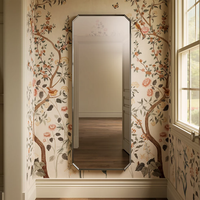 Claude™ rectangular framed mirror by Kohler mounted on floral wallpaper
