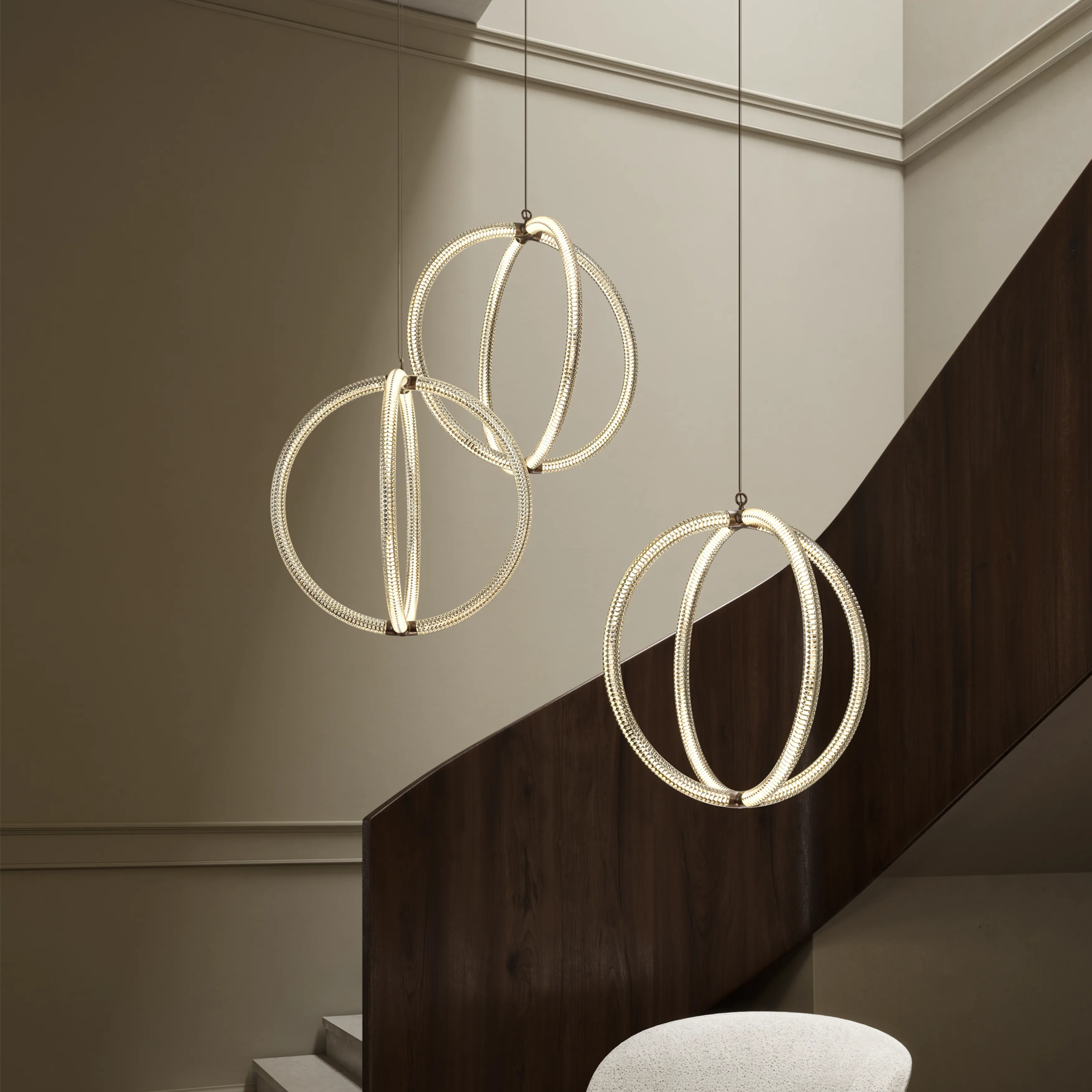 Three modern Luminora pendant lights  hanging above a staircase.