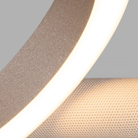 Close-up of a textured  ring light and a beige fabric strip on Pallana Suspension Light.