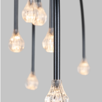 Close-up of hanging light bulbs with black cords of Starfall Pendant