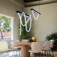Modern dining area with 2 Moooi Tubelight Suspension light fixtures one 150cm and one 500cm.