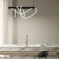 Modern kitchen with marble countertop, patterned wallpaper, and Tubelight pendant light.