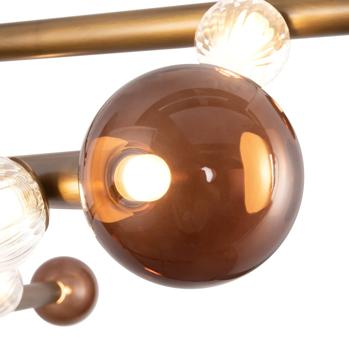 Details of Kuzco Reese Chandelier with vintage brass finish and amber glass