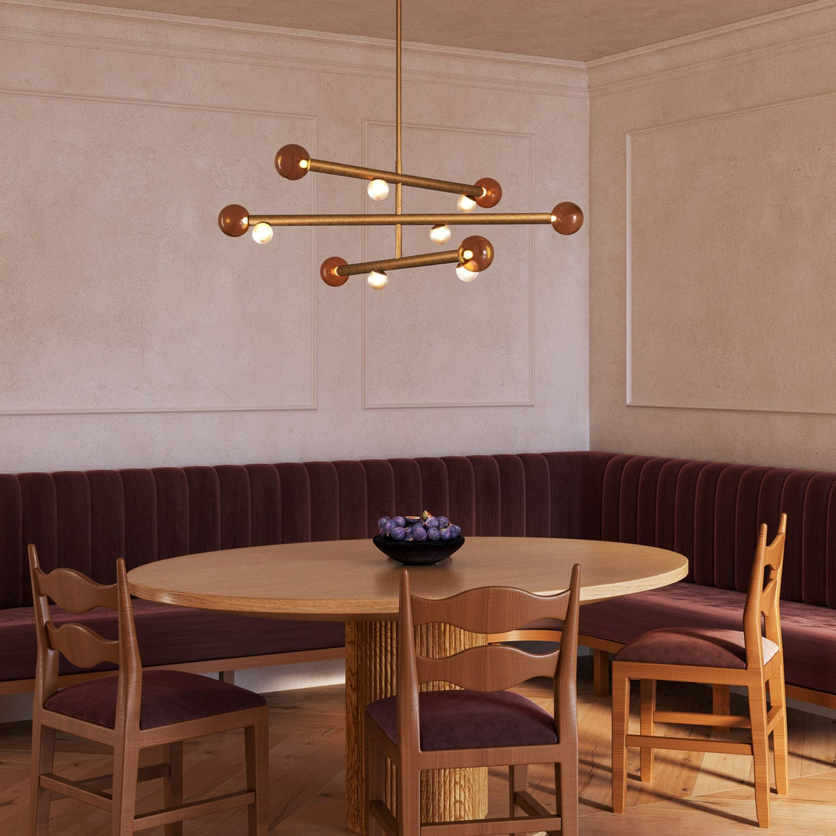 Kuzco Reese Chandelier in vintage brass finish above dining table