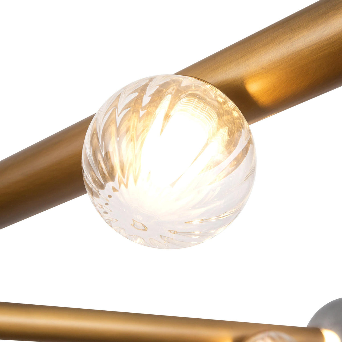 Details of Kuzco Reese Chandelier with vintage brass finish and glass globe