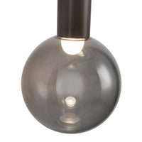 Close-up view of Kuzco Reese Wall Sconce in urban bronze finish with smoke glass