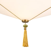 Details of Reeve pendant light fixture with gold tassel and green accent bead