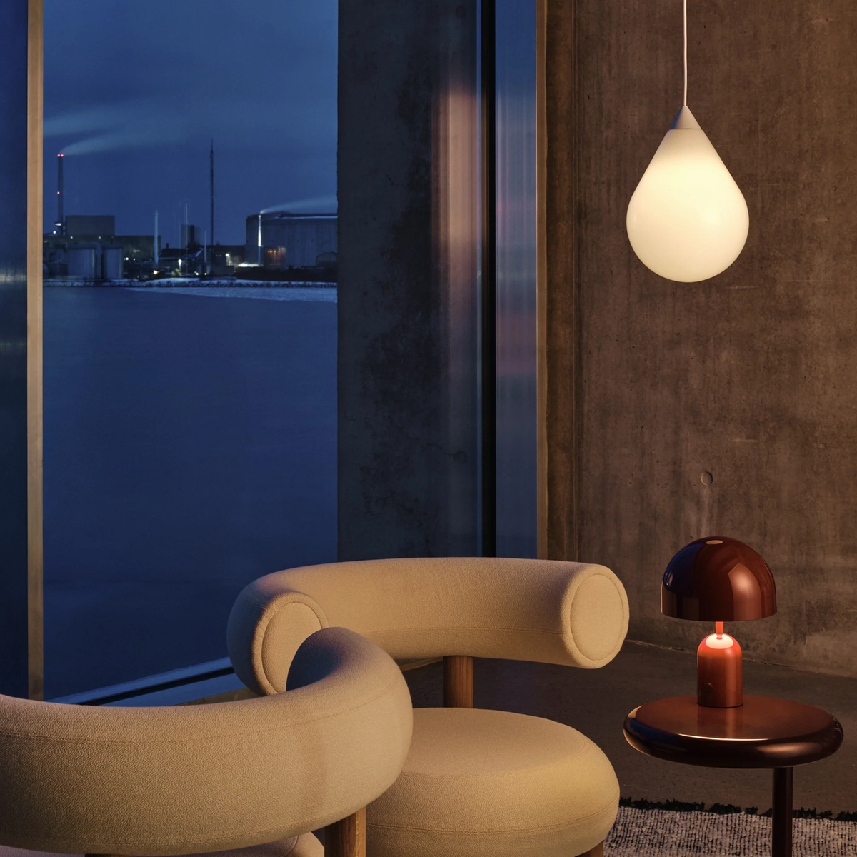 Tom Dixon Flare Pendant hanging in modern living room at night