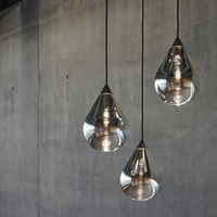 Tom Dixon Flare Pendant lights in silver finish with reflective glass teardrop design