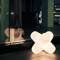 Tom Dixon Jack Portable Light glowing near glass window