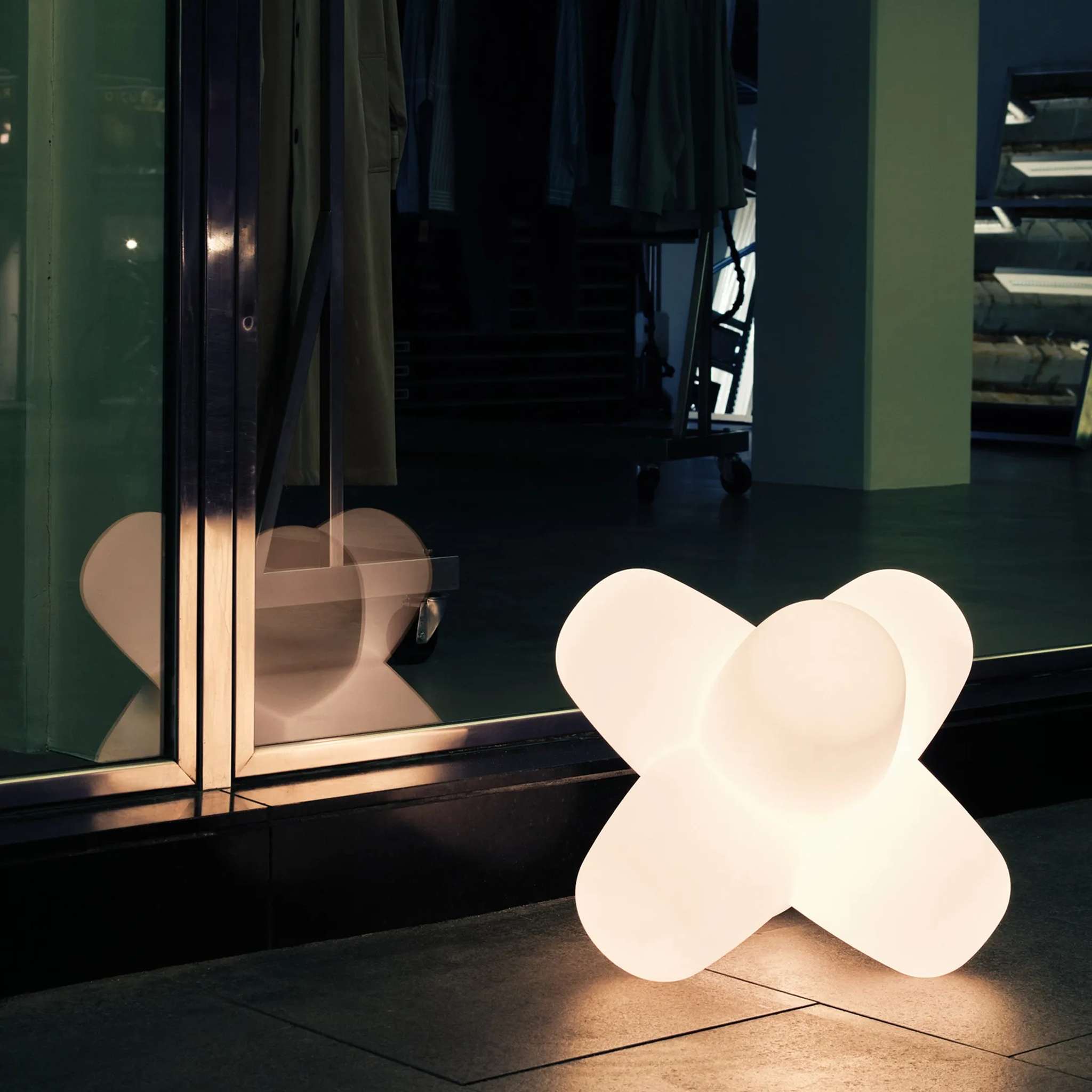 Tom Dixon Jack Portable Light glowing near glass window