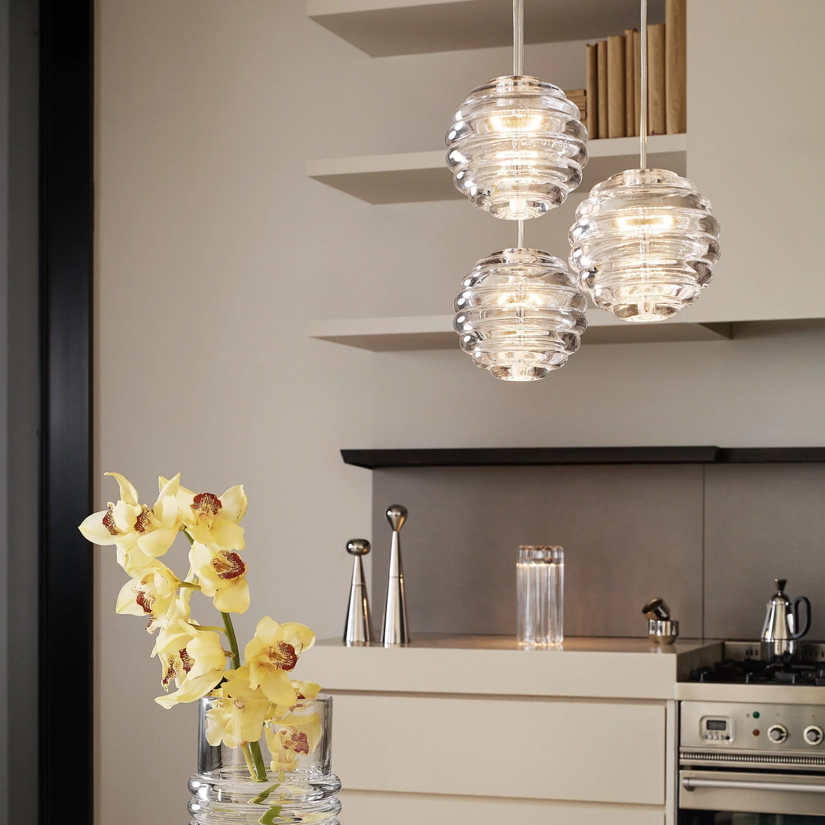 Tom Dixon Press LED Sphere Pendant clear glass trio hanging over kitchen counter
