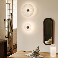 Tom Dixon Press LED Table Lamp in Frosted finish on wooden table in cozy room