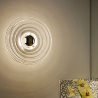 Tom Dixon Press Led Wall Light with clear finish mounted on wall