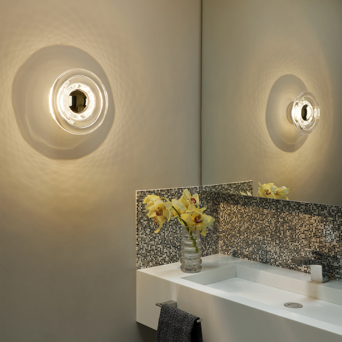 Tom Dixon Press led wall light in clear finish above bathroom sink