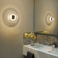 Tom Dixon Press led wall light in clear finish above bathroom sink