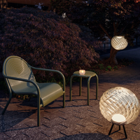 Tom Dixon Whirl LED Portable Floor and Hanging Light illuminated outdoors