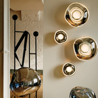 Melt Wall Light collection displayed on a wall, glowing with warm light in a contemporary interior.