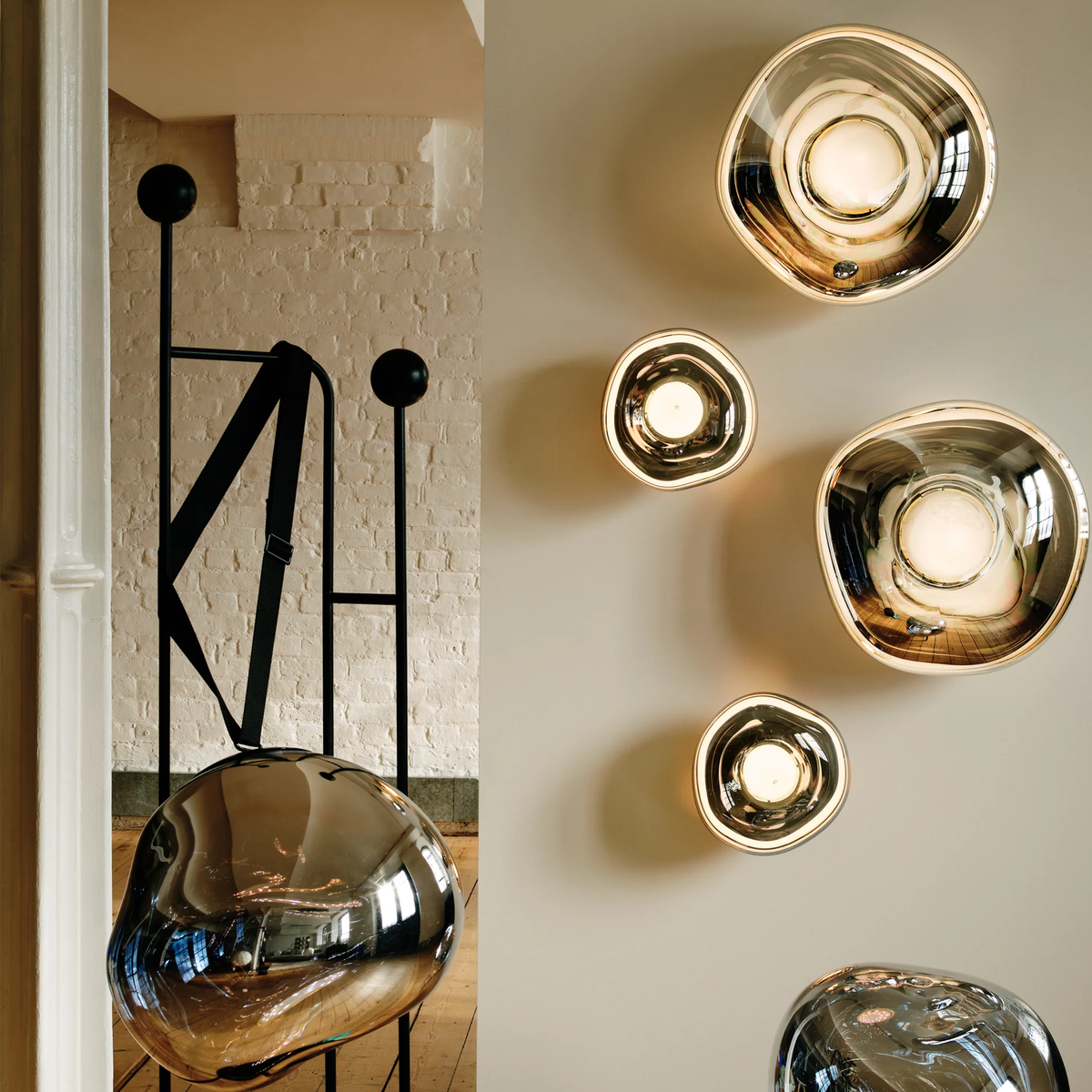 Melt Wall Light collection displayed on a wall, glowing with warm light in a contemporary interior.