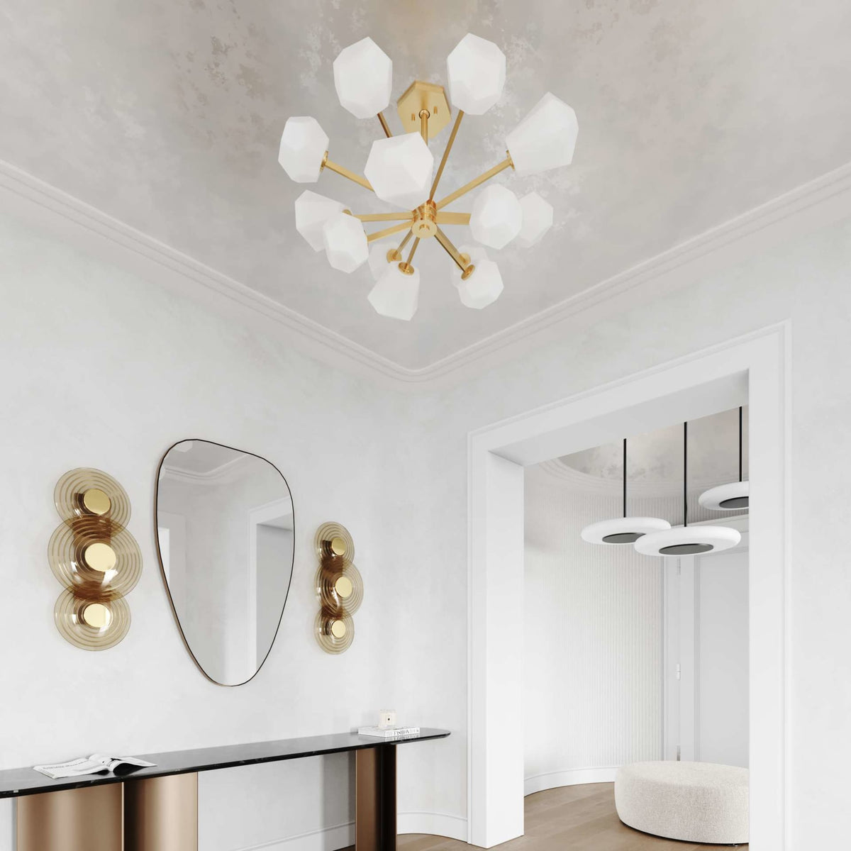 Two Hudson Valley Griston Wall Sconces in gold finish mounted on white wall